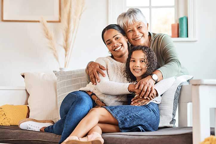 Grandmother spending time with her daughter and grandchild at home